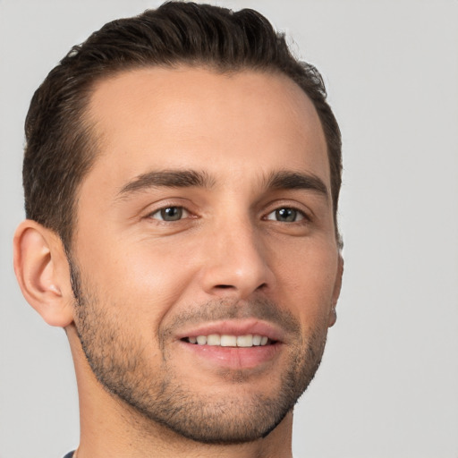 Joyful white young-adult male with short  brown hair and brown eyes