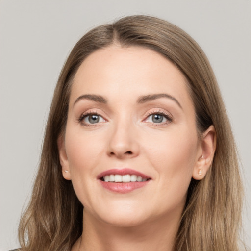 Joyful white young-adult female with long  brown hair and grey eyes