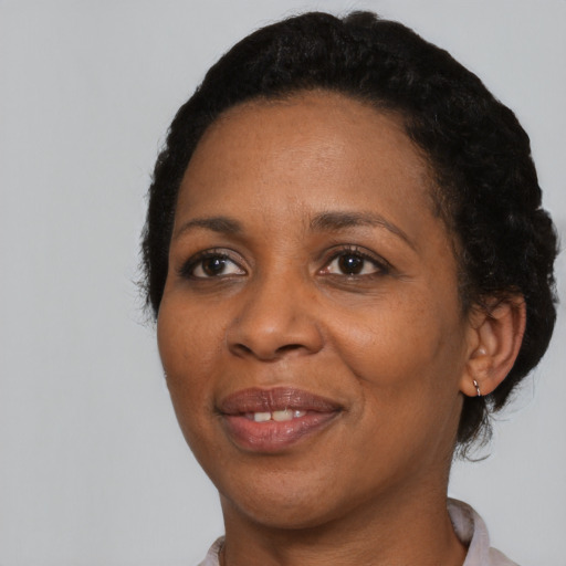 Joyful black adult female with short  black hair and brown eyes