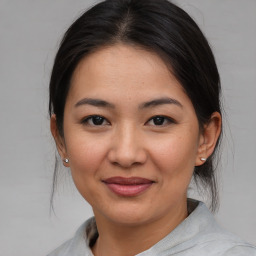 Joyful asian young-adult female with medium  brown hair and brown eyes