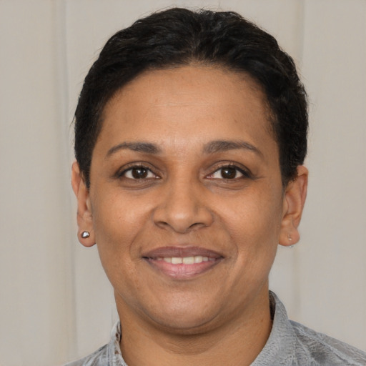 Joyful black young-adult female with short  black hair and brown eyes