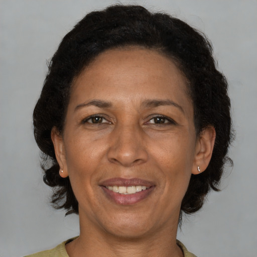 Joyful black adult female with short  brown hair and brown eyes