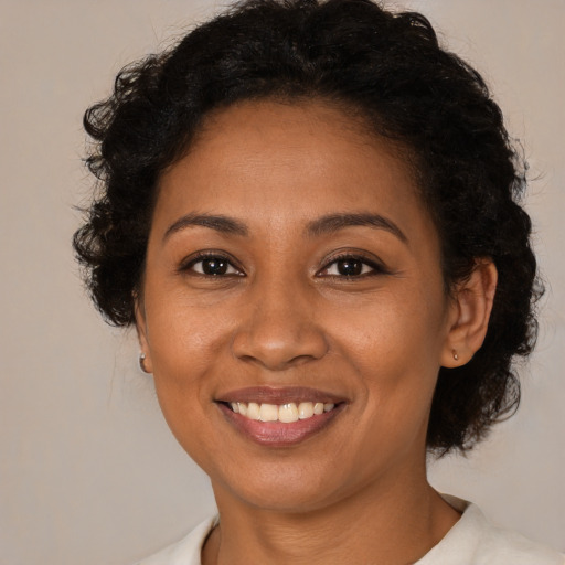 Joyful latino young-adult female with short  brown hair and brown eyes