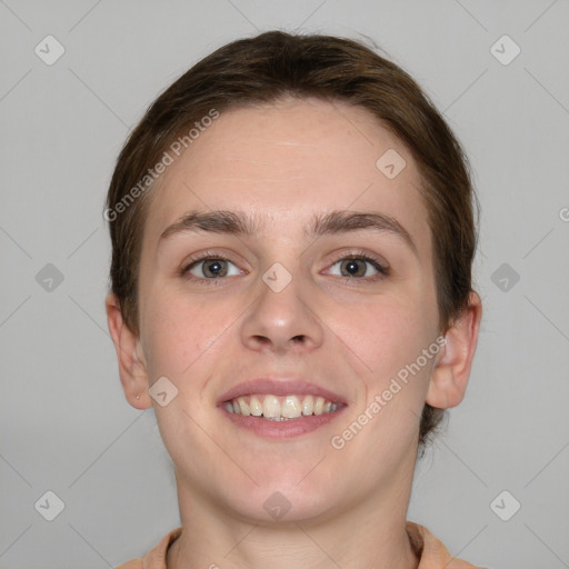 Joyful white young-adult female with short  brown hair and grey eyes