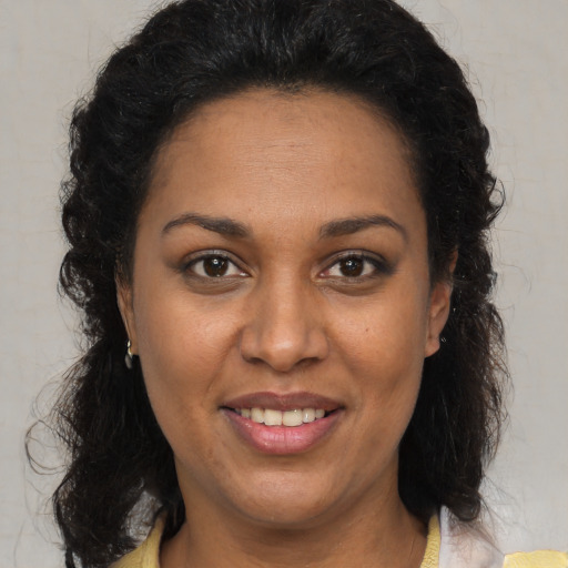 Joyful black young-adult female with medium  brown hair and brown eyes