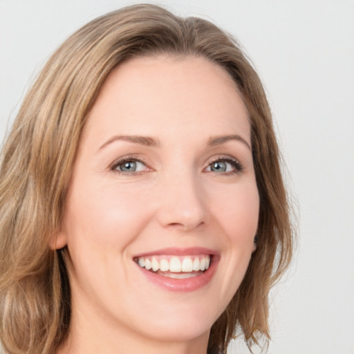 Joyful white young-adult female with medium  brown hair and green eyes