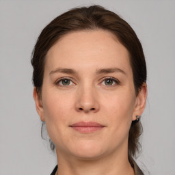 Joyful white adult female with medium  brown hair and grey eyes