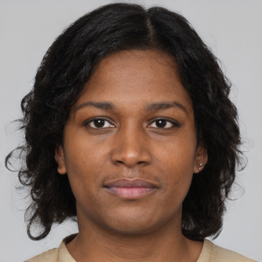 Neutral black young-adult female with medium  brown hair and brown eyes
