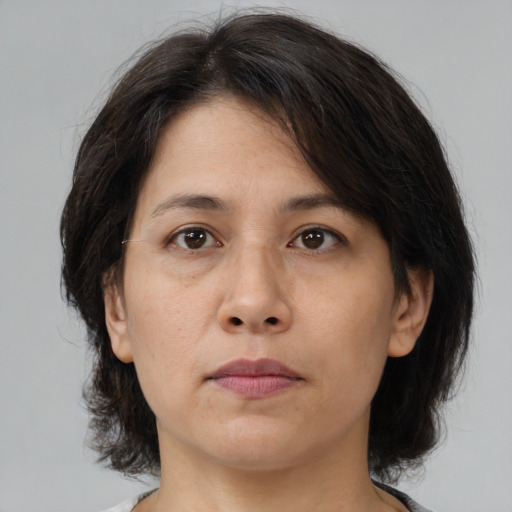 Neutral asian adult female with medium  brown hair and brown eyes