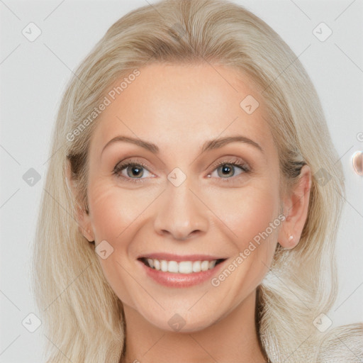 Joyful white young-adult female with long  brown hair and blue eyes