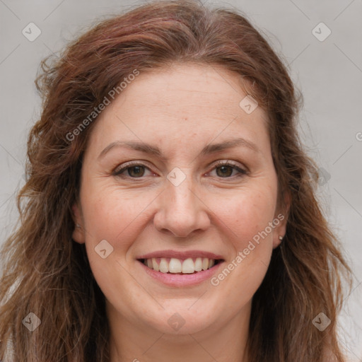 Joyful white adult female with long  brown hair and brown eyes