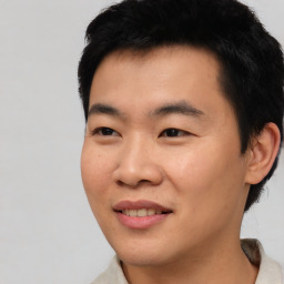 Joyful asian young-adult male with short  black hair and brown eyes