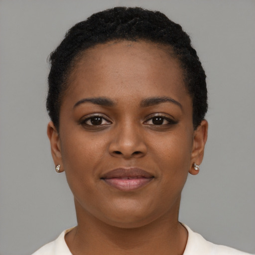 Joyful black young-adult female with short  black hair and brown eyes