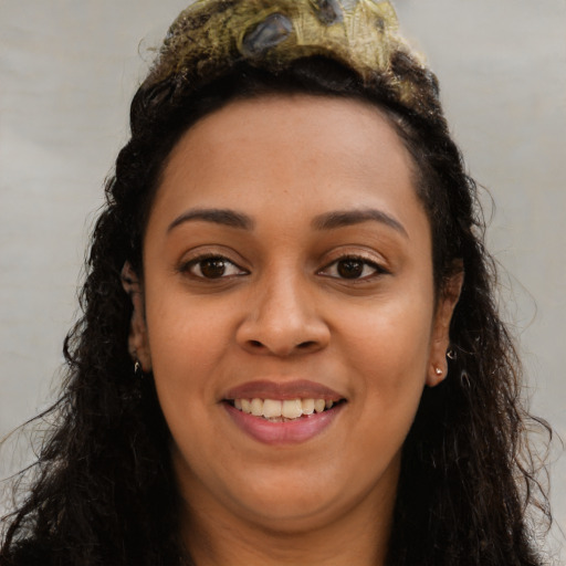Joyful latino young-adult female with long  brown hair and brown eyes