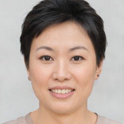 Joyful asian young-adult female with short  brown hair and brown eyes