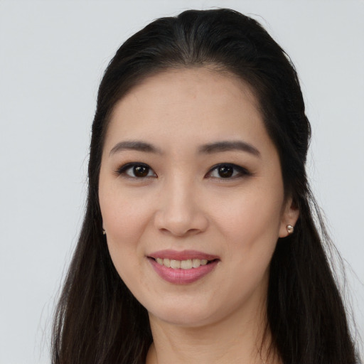 Joyful asian young-adult female with long  brown hair and brown eyes