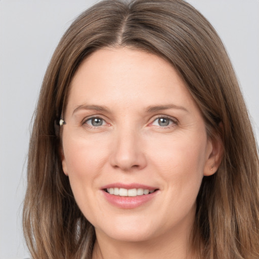 Joyful white young-adult female with medium  brown hair and grey eyes