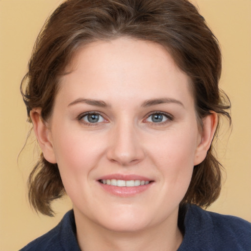 Joyful white young-adult female with medium  brown hair and grey eyes