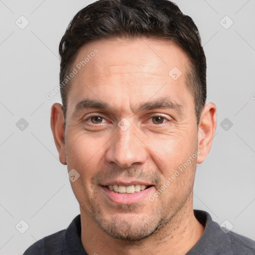 Joyful white adult male with short  brown hair and grey eyes