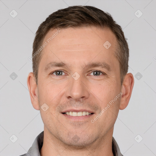 Joyful white adult male with short  brown hair and brown eyes