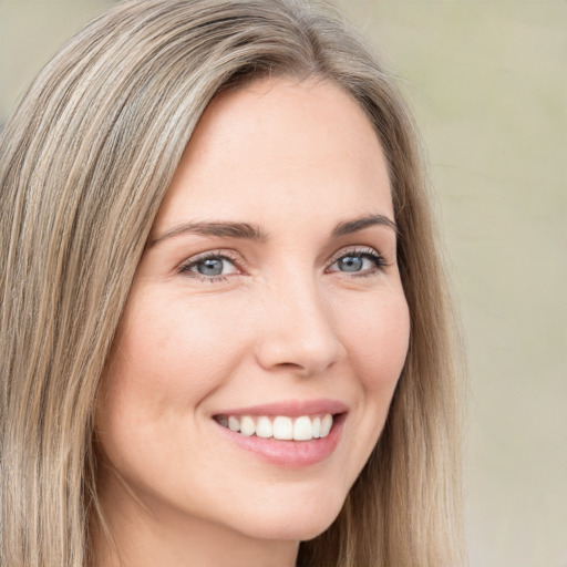 Joyful white young-adult female with long  brown hair and green eyes