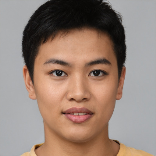 Joyful asian young-adult male with short  black hair and brown eyes