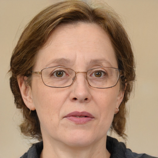 Joyful white middle-aged female with medium  brown hair and blue eyes