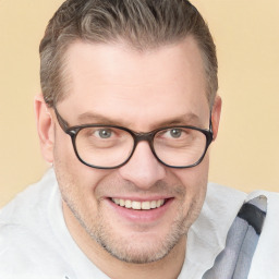 Joyful white adult male with short  brown hair and brown eyes