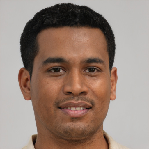 Joyful latino young-adult male with short  black hair and brown eyes