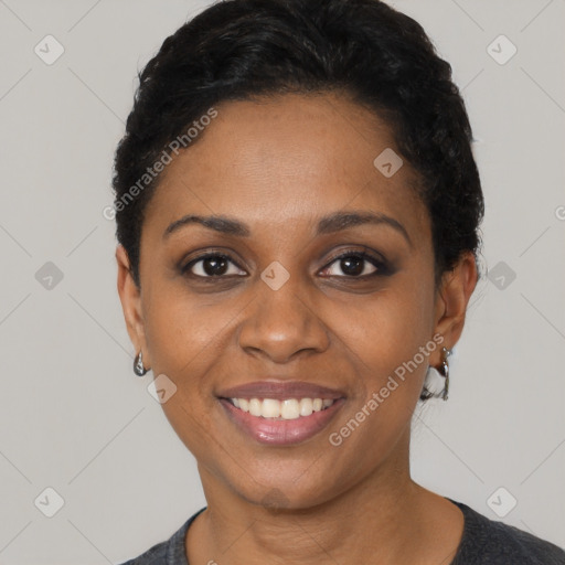 Joyful black young-adult female with short  black hair and brown eyes