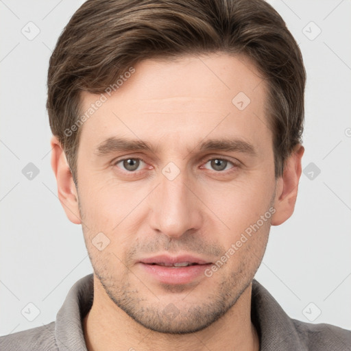 Joyful white young-adult male with short  brown hair and grey eyes