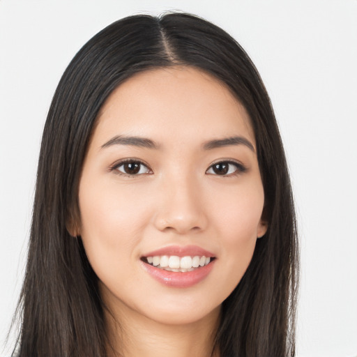 Joyful asian young-adult female with long  brown hair and brown eyes