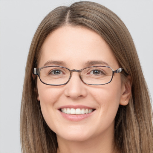 Joyful white young-adult female with long  brown hair and grey eyes