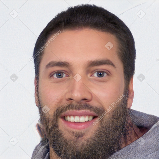 Joyful white young-adult male with short  black hair and brown eyes