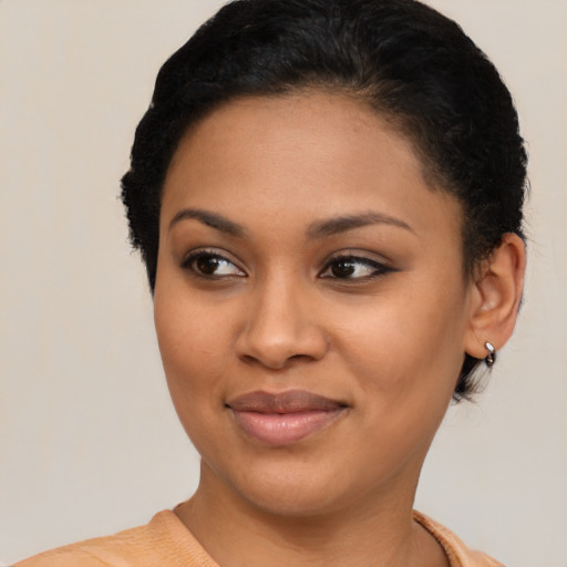 Joyful black young-adult female with short  brown hair and brown eyes