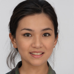 Joyful asian young-adult female with medium  brown hair and brown eyes