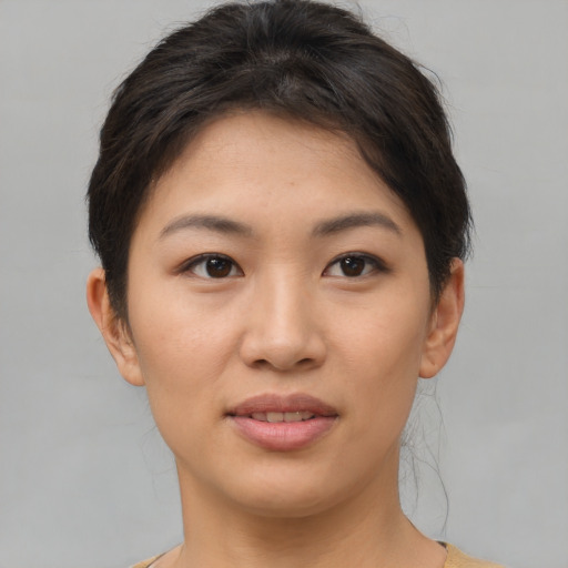 Joyful asian young-adult female with short  brown hair and brown eyes