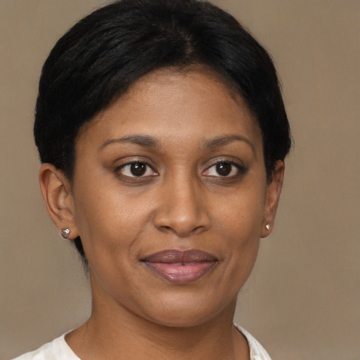 Joyful black young-adult female with short  brown hair and brown eyes