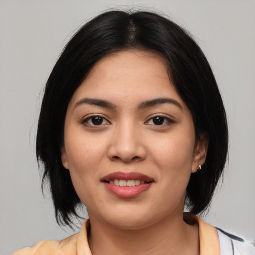 Joyful asian young-adult female with medium  black hair and brown eyes