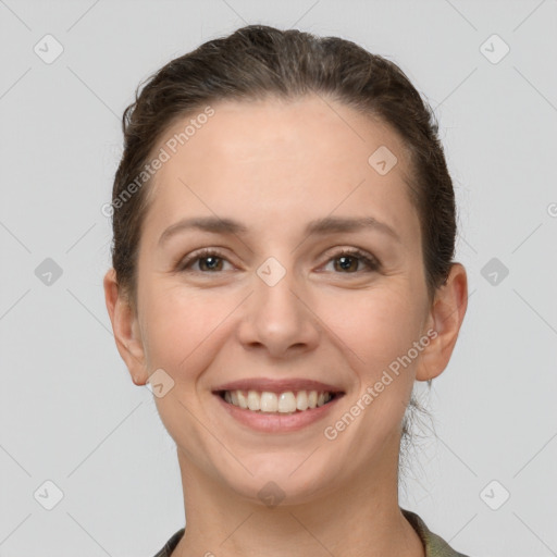 Joyful white young-adult female with short  brown hair and grey eyes