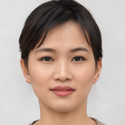 Joyful asian young-adult female with short  brown hair and brown eyes