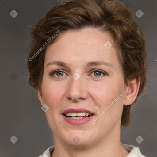 Joyful white adult female with short  brown hair and grey eyes