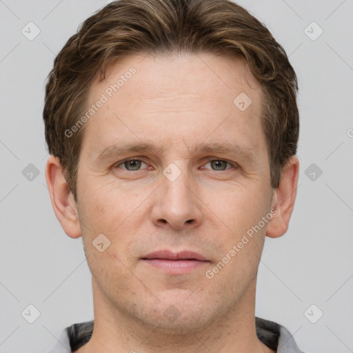 Joyful white adult male with short  brown hair and grey eyes
