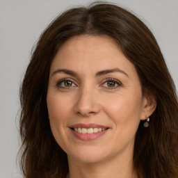 Joyful white young-adult female with long  brown hair and green eyes