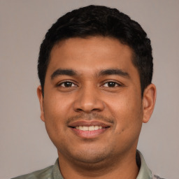 Joyful latino young-adult male with short  black hair and brown eyes