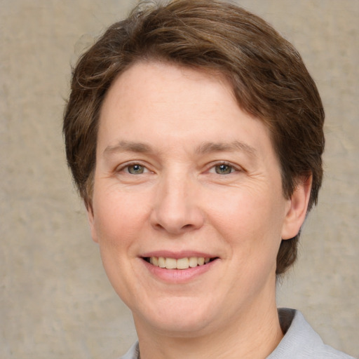 Joyful white adult female with short  brown hair and grey eyes