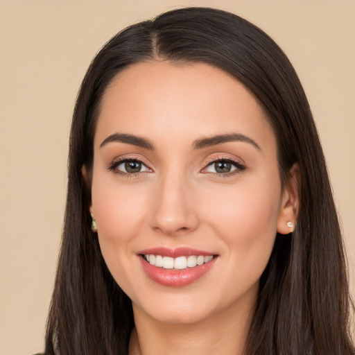 Joyful white young-adult female with long  black hair and brown eyes