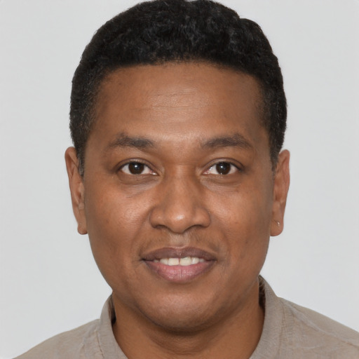 Joyful latino young-adult male with short  brown hair and brown eyes