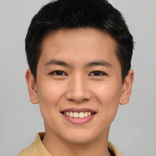 Joyful asian young-adult male with short  brown hair and brown eyes