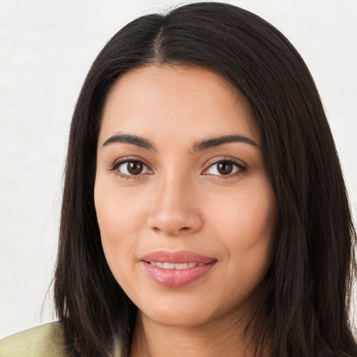 Joyful latino young-adult female with long  brown hair and brown eyes